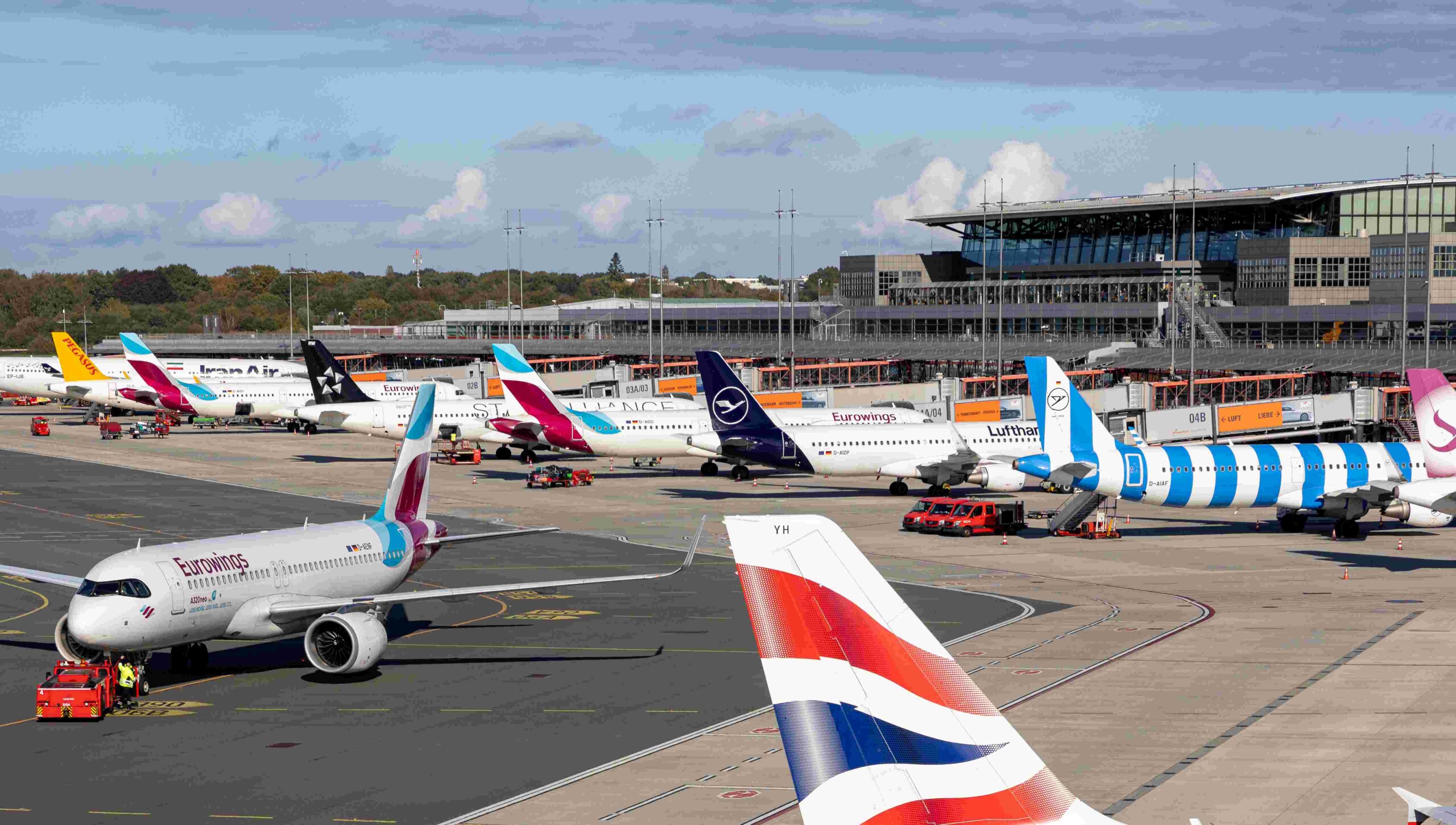 Aircraft from various airlines are parked on the tarmac