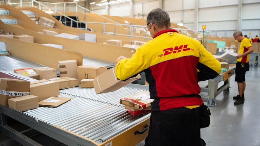 Deutsche Post employee sorts letters by hand